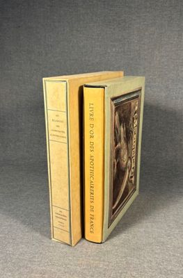 two books sitting on top of each other on a gray surface