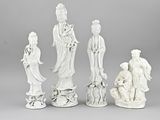 four white figurines of asian figures sitting next to each other