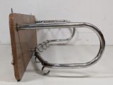 a metal object that is hanging on a wall