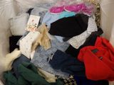 a white box filled with clothes and a book