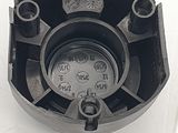 a close up of a black clock on a white surface