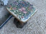 a small stool sitting on the floor in front of a wall