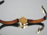 a close up of a watch on a table