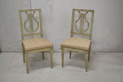 pair of antique painted chairs with upholstered cushions