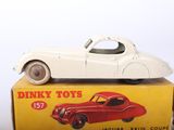 a white toy car sitting on top of a box