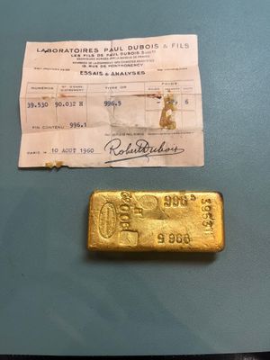 a close up of a gold bar and a receipt on a table