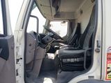 a white truck with black seats in the back of it