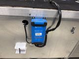 a blue and black device attached to a metal shelf