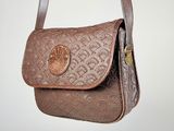 brown leather purse with a coin on it hanging from a hook