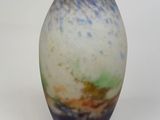 a blue and white vase sitting on a white surface