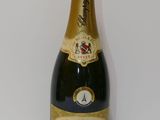 the bottle of champagne is sitting on the table next to the wall