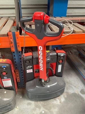 a picture of a red and black machine in a warehouse