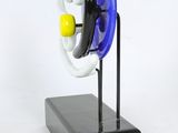 an image of a blue and white object on a black stand
