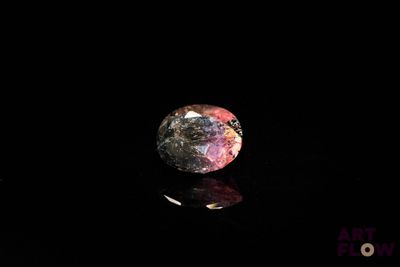 a picture of a pink and purple diamond on a black surface