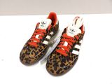 leopard print adidas sneakers with red laces on a white surface