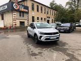 the silver car is parked in front of a building in a parking lot