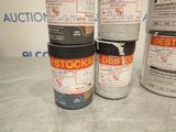 several cans of paint sitting on top of a table next to each other