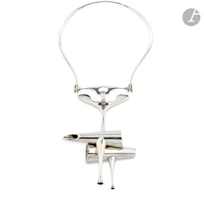 silver plated necklace with a pair of scissors attached to it ' s neck