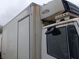 a white truck with a television on top of it