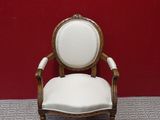 a white chair that is sitting in front of a red wall