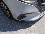 a close up of the front of a silver car