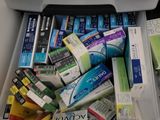 many different types of toothpaste in a plastic box