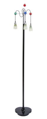 a black metal floor lamp with three lights and a black base