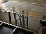 a table that has a glass top in the middle of the room