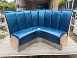 a blue bench made out of cardboard sitting on a table