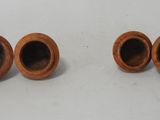 two brown vases sitting next to each other on a table