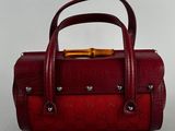 burgundy leather handbag with gold hardware and handle