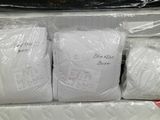 three bags of white yarn wrapped in plastic