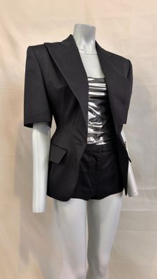 a mannequin dressed mannequin wearing a black jacket and skirt
