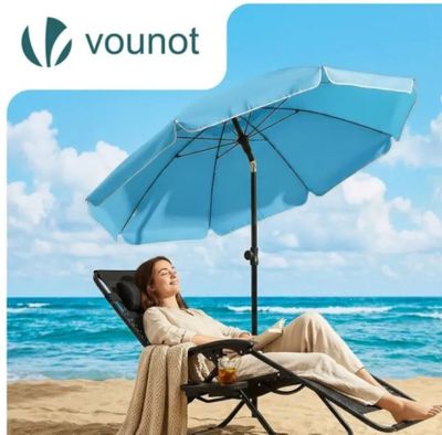 an image of a woman sitting on a beach chair under an umbrella