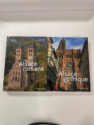 a clock that is on the wall next to a book