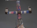 sculpture of a wooden pole with a red, white, and blue design on it