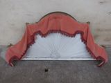 a red and white fan sitting on top of a window sill