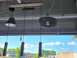 three lights hanging from the ceiling of a restaurant