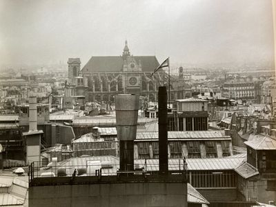a black and white photo of a city with a clock tower