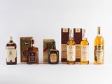 several different types of whiskys are lined up on a white surface