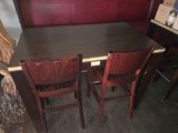 deux chaises en bois placées autour d'une table dans une pièce