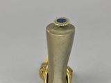 a close up of a gold ring with a blue stone on it