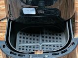 philips air fryer on a wooden table with the lid open
