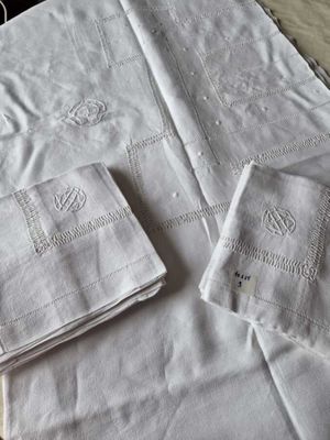two white napkins and a pair of white napkins on a table