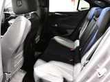the back seats of a car with the door open and the driver ' s seat folded down