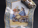 a plate with a picture of a man and a woman sitting at a table
