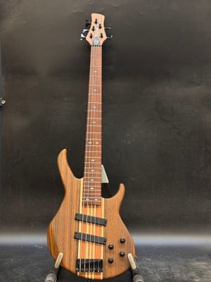 a close up of a bass guitar on a stand on a table