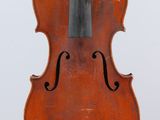 an old violin sitting on top of a white surface