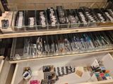 many pens and pens on display in a glass case
