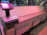 a counter with a pink light on it in a store
